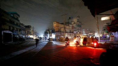 Image of a cityscape during a heavy downpour, with dark clouds and lightning in the background, symbolizing the challenges faced during power outages in Nagpur.