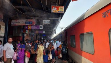 Passengers enjoying the cool mist at Nagpur Railway Station during summer.