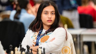 Divya Deshmukh holding the World Junior Girls' Chess Championship trophy with a