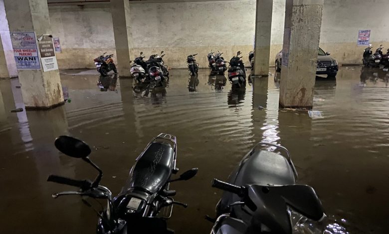 NMC team draining water from a flooded basement in Nagpur.