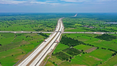 A view of the Mumbai-Nagpur Expressway nearing completion, showcasing tunnels and viaducts amidst challenging terrain.