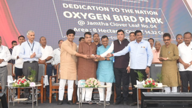 Mukesh Ambani launching a rice straw-based CNG project amidst green surroundings.