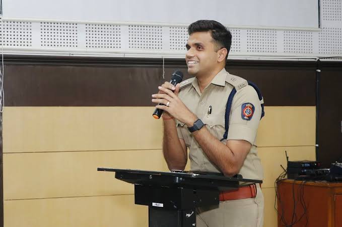 DCP Chandak: A police officer inspecting a seized bike after a rider made a reel while driving in Nagpur's traffic crackdown. Nagpur traffic rules