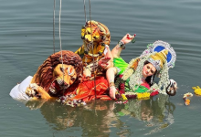 Durga idol immersion at Koradi artificial tank promoting eco-friendly practices.