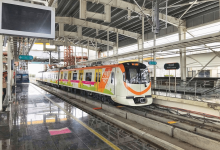 A busy Nagpur Metro station with passengers during festive celebrations.