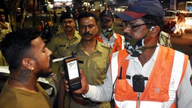 A police officer stopping a car on a road, symbolizing enforcement against drunk driving during festivals.