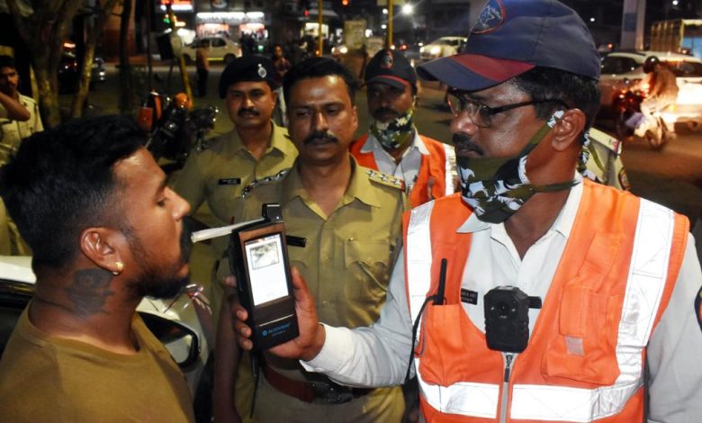 A police officer stopping a car on a road, symbolizing enforcement against drunk driving during festivals.