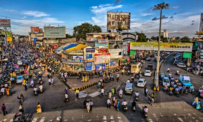 Nagpur: A bustling cityscape with a modern multi-storey parking plaza in the foreground, symbolizing Nagpur's smart parking solutions. | NSSCDCL