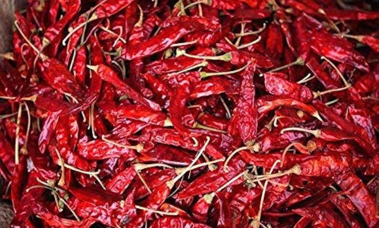 rain-soaked chilli sacks in a market yard.