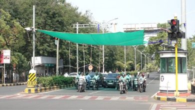 Green nets providing shade at a traffic signal in Nagpur, offering relief to motorists from the intense summer heat.