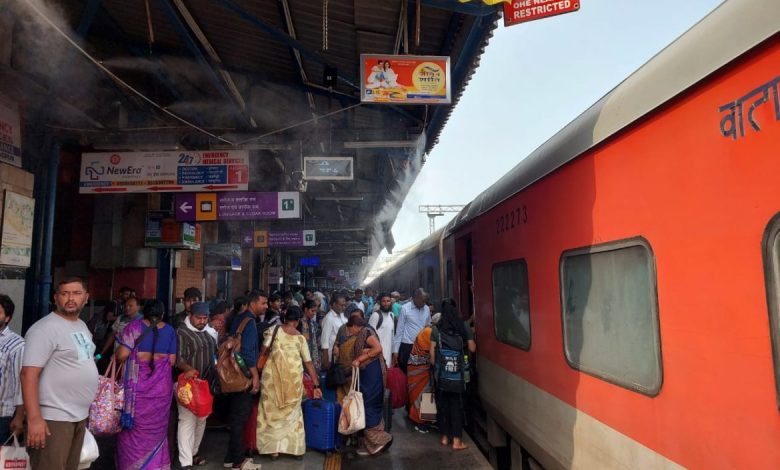 Passengers enjoying the cool mist at Nagpur Railway Station during summer.