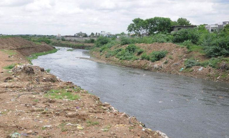 A clean river flowing through urban landscape, symbolizing environmental restoration efforts in Nagpur.