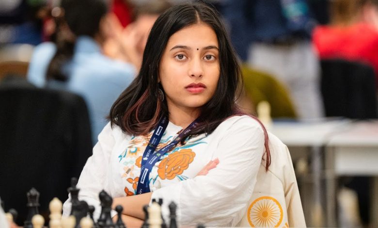 Divya Deshmukh holding the World Junior Girls' Chess Championship trophy with a