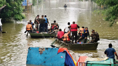 A flooded street in Nagpur with submerged homes and rescue operations underway.