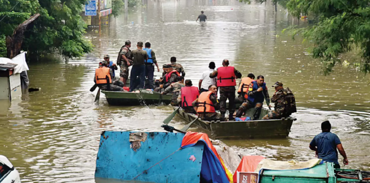 A flooded street in Nagpur with submerged homes and rescue operations underway.