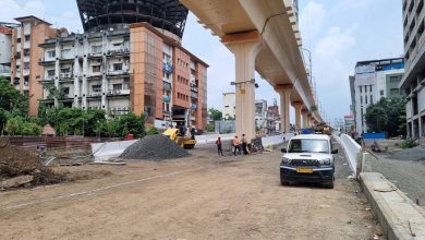 A view of the Kamptee Road Flyover in Nagpur nearing completion, with construction equipment and the city skyline in the background.