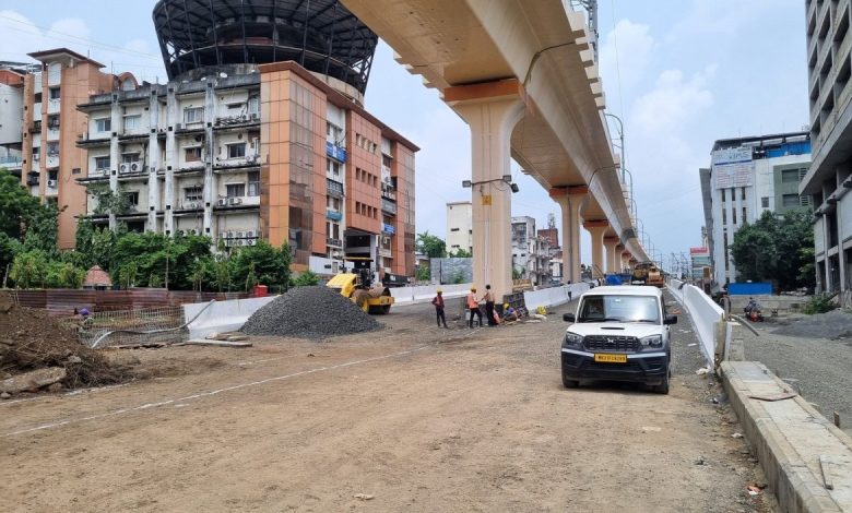 A view of the Kamptee Road Flyover in Nagpur nearing completion, with construction equipment and the city skyline in the background.