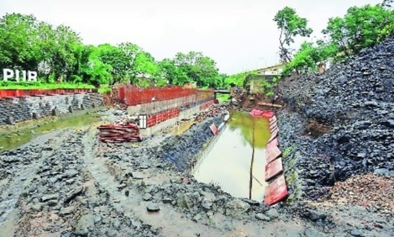 Ambazari Bridge construction site with delayed completion sign