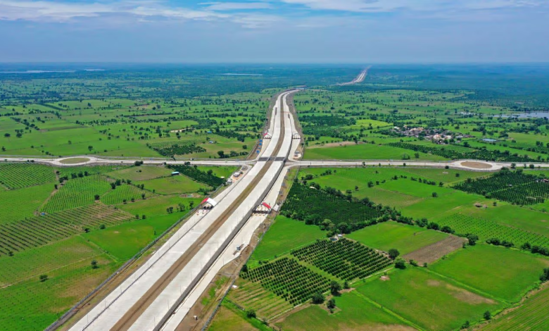 A view of the Mumbai-Nagpur Expressway nearing completion, showcasing tunnels and viaducts amidst challenging terrain.