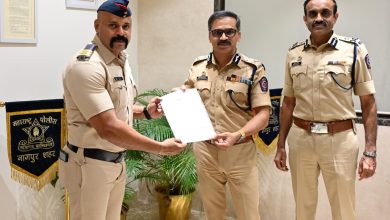 scam alert: Police officer preventing ATM theft inside a kiosk in Nagpur.