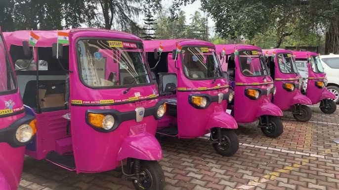 Nagpur: A vibrant pink e-rickshaw driven by a confident woman, symbolizing empowerment and sustainability.