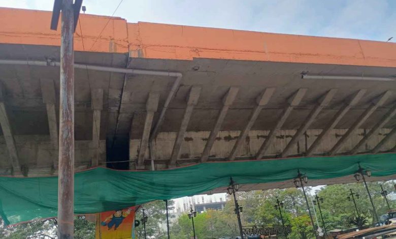 Nagpur: Damaged Butibori flyover section under inspection with visible cracks and exposed iron bars.