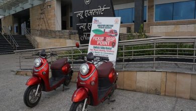 Commuter using a Switch E-Ride e-scooter near a MahaMetro station.