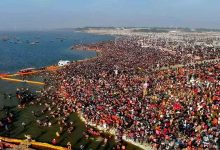 A helicopter flying over the vibrant Maha Kumbh Mela 2025 in Prayagraj, showcasing the grand event from an aerial perspective.