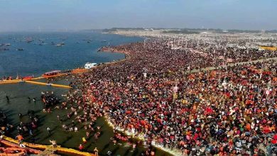 A helicopter flying over the vibrant Maha Kumbh Mela 2025 in Prayagraj, showcasing the grand event from an aerial perspective.