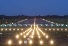 Aerial view of Nagpur Airport runway undergoing recarpeting, showcasing smooth new layers and construction equipment.