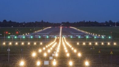 Aerial view of Nagpur Airport runway undergoing recarpeting, showcasing smooth new layers and construction equipment.