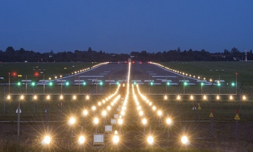 Aerial view of Nagpur Airport runway undergoing recarpeting, showcasing smooth new layers and construction equipment.