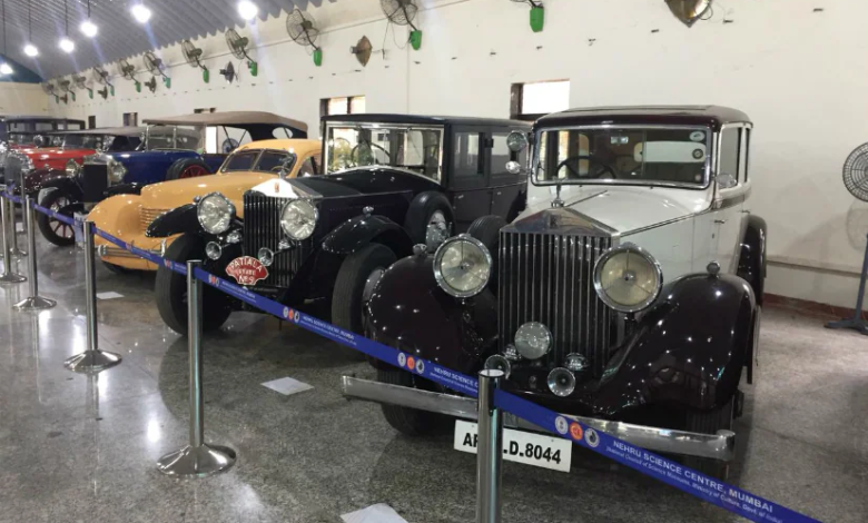 A lineup of beautifully restored vintage cars and bikes at an exhibition. Raman Science Centre | Vintage Car and Bike Display