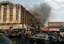 An artistic representation of Nagpur’s modernized Cotton Market with high-rise buildings, green spaces, and bustling commercial activity.