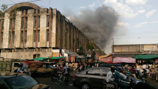 An artistic representation of Nagpur’s modernized Cotton Market with high-rise buildings, green spaces, and bustling commercial activity.