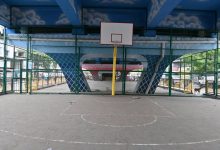 Transformed flyover space in Nagpur featuring a basketball court, green seating areas, and a public gym setup